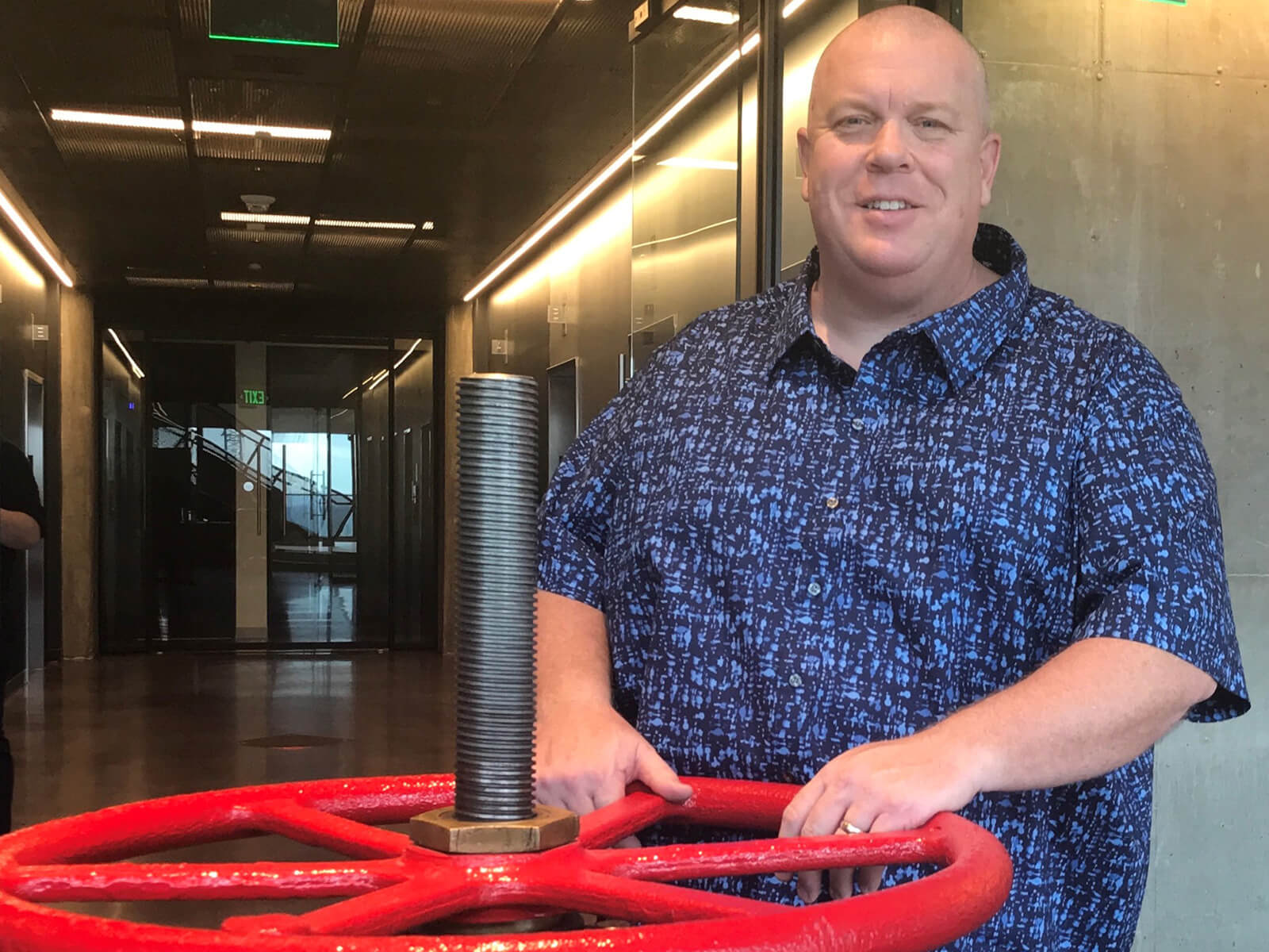 Eric Smith poses with the actual valve at the Valve office