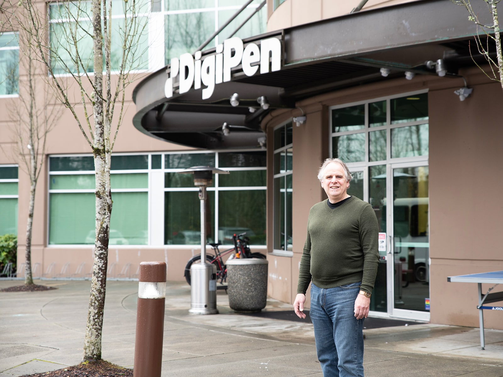 Mark Henne poses in front of the DigiPen main entrance.