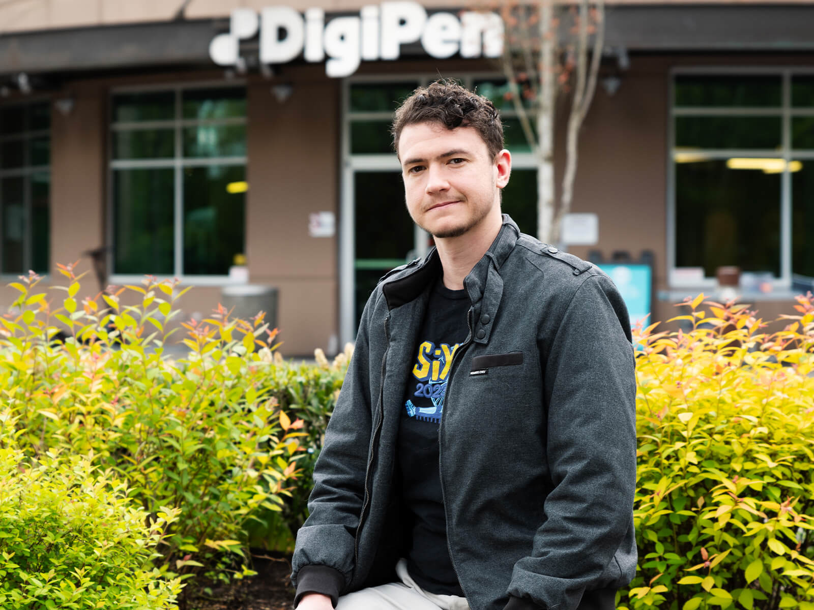 Outgoing DigiPen Student Union President Li Buam stands in front of the DigiPen Campus