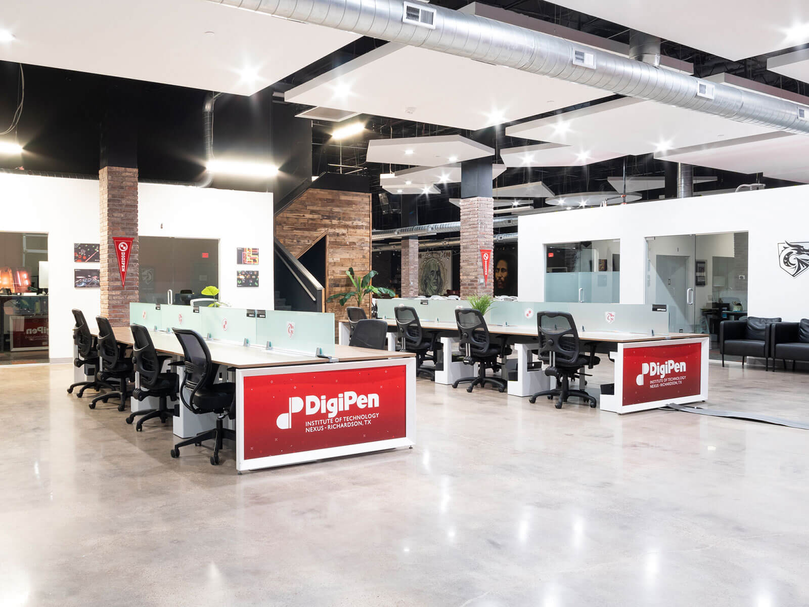 An open workspace area with multiple stations with the DigiPen logo on them
