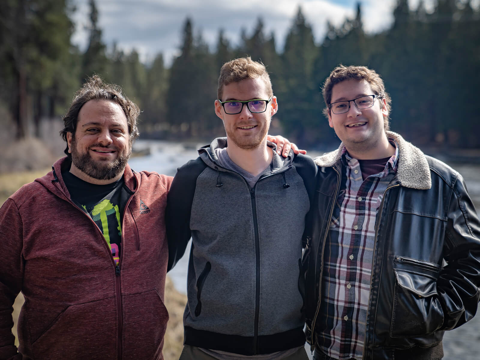 Jacob Fieth, Geoffry Hammon, and Sawyer Paradise pose on the Deschutes River near SIE Bend Studio’s offices.