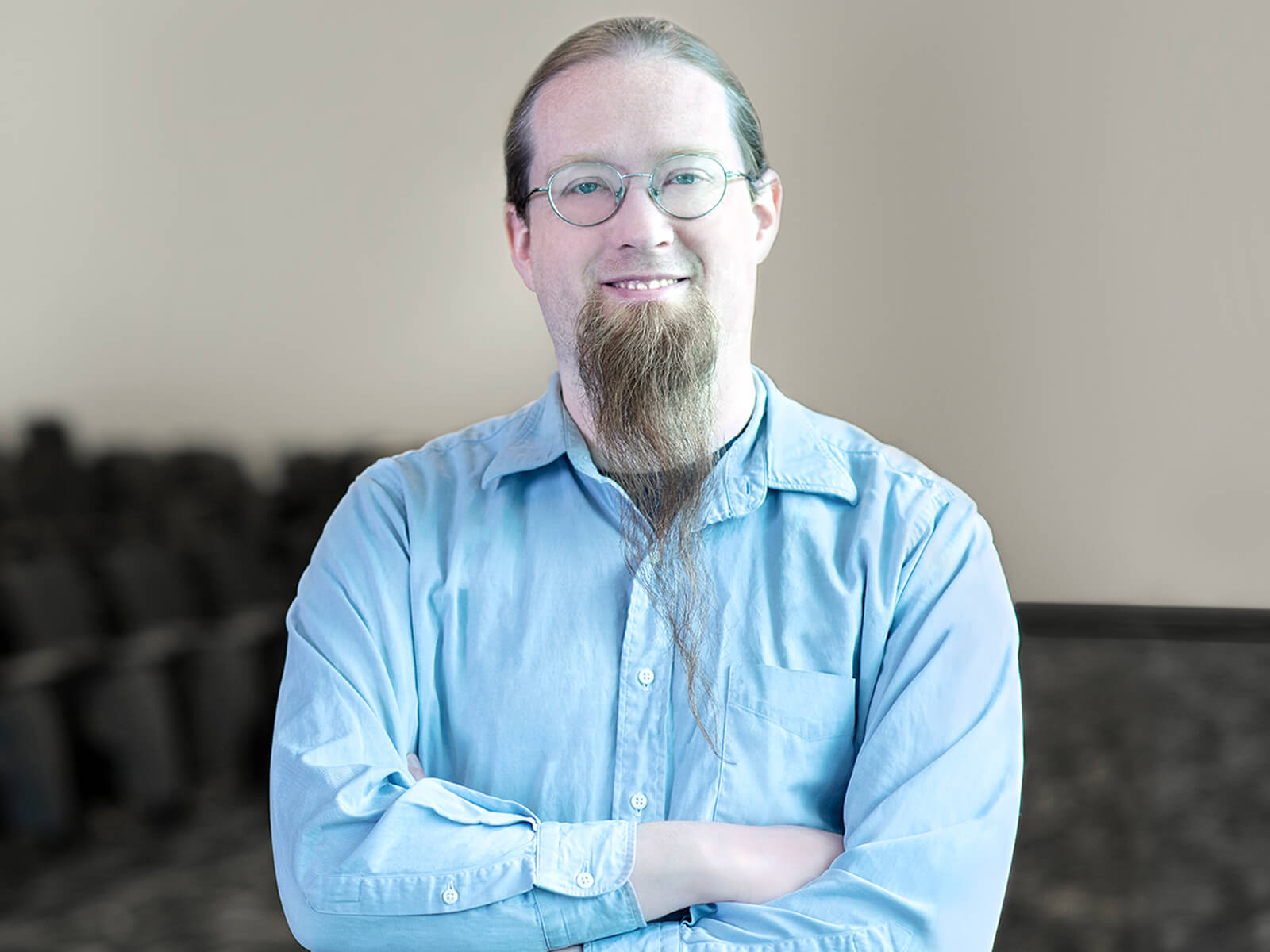 Game Design Program Director Jeremy Holcomb smiles for the camera in a DigiPen auditorium.