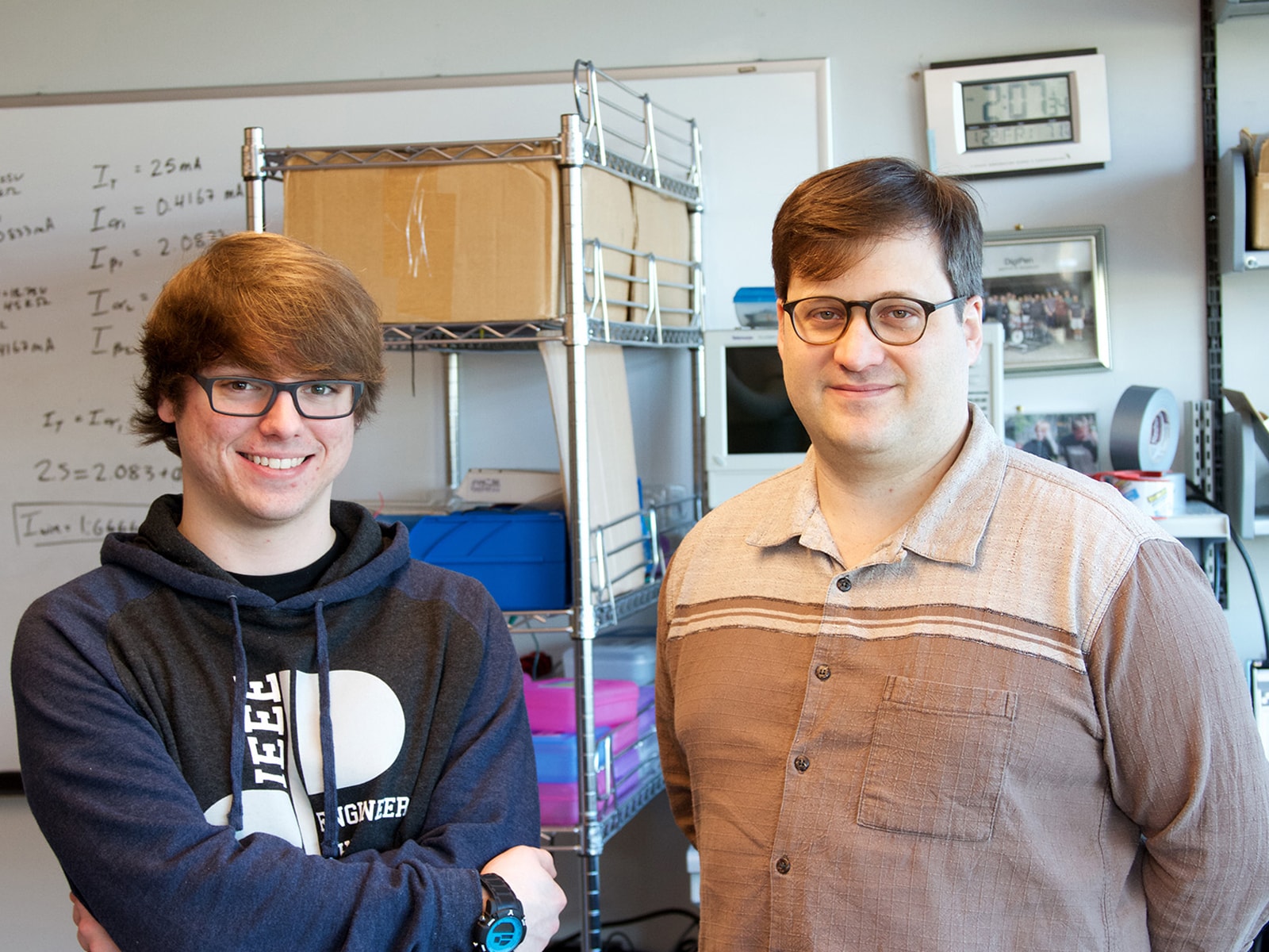 DigiPen student Jimi Huard and professor Jeremy Thomas smiling side by side in a DigiPen computer engineering lab