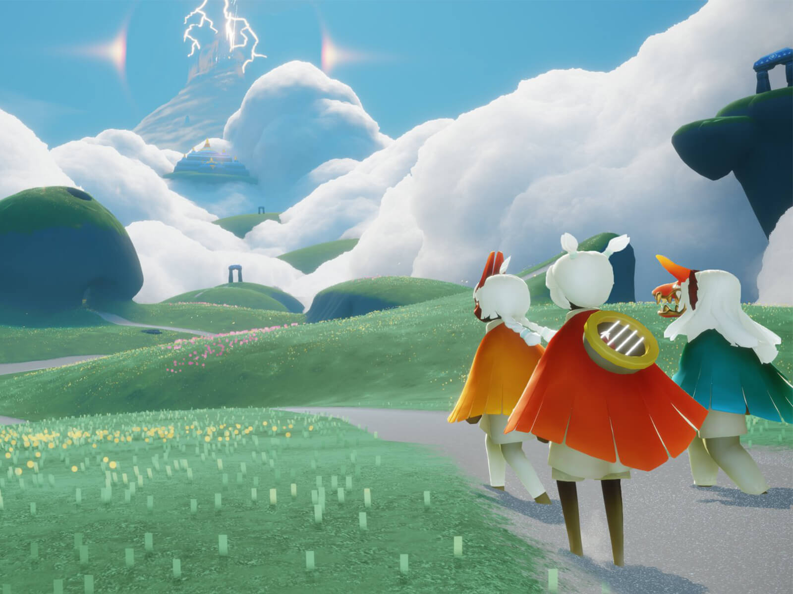 Three characters from Sky: Children of the Light look out at rolling green fields.
