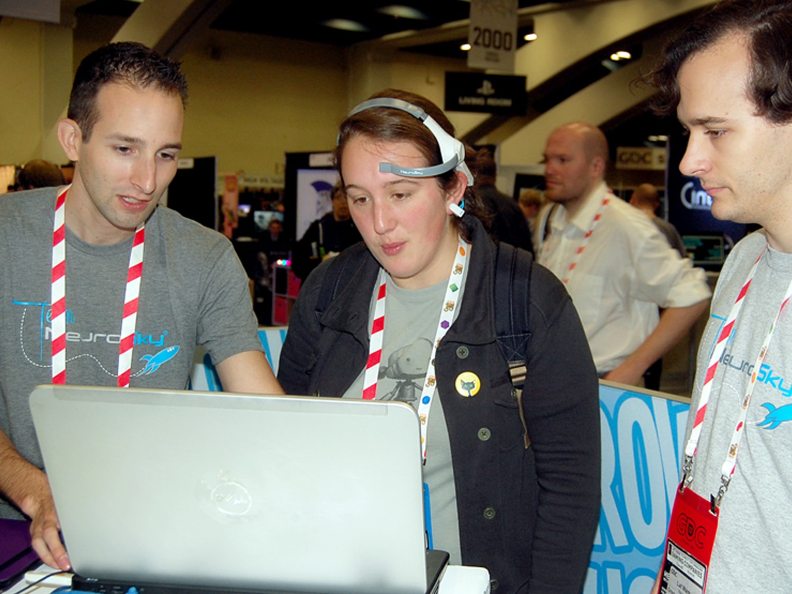 DigiPen alumnus Lat Ware and a colleague explaining their EEG-powered game, Throw Trucks With Your Mind, to a player at GDC