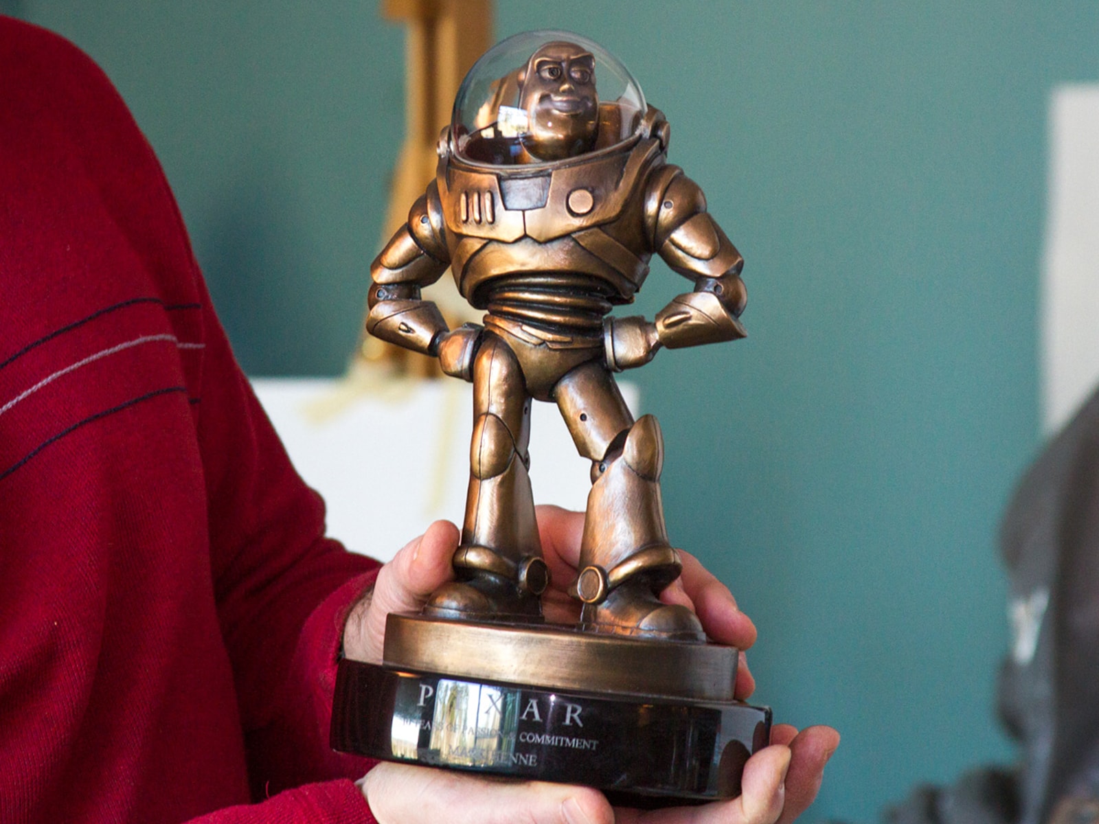 DigiPen Digital Arts lecturer Mark Henne shows his Pixar Award for Passionate Commitment, a bronze Buzz Lightyear trophy