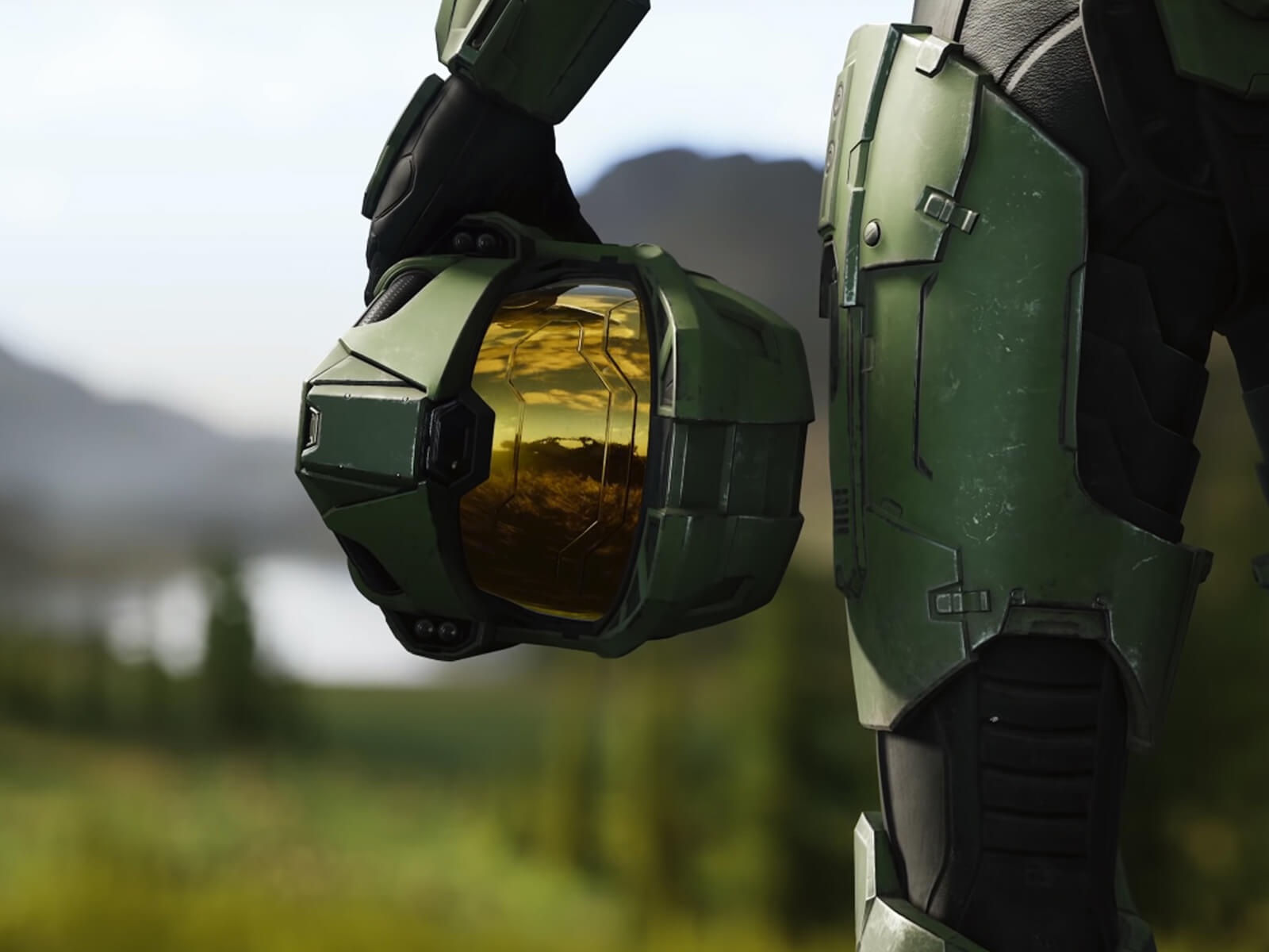 A Halo Infinite screenshot of Master Chief holding his helmet at his waist.