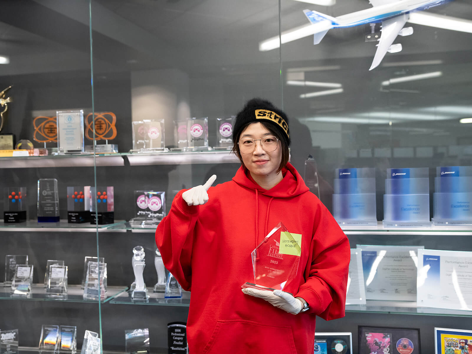 Mingyuan Li holds her Catalina Film Festival trophy on campus at DigiPen.