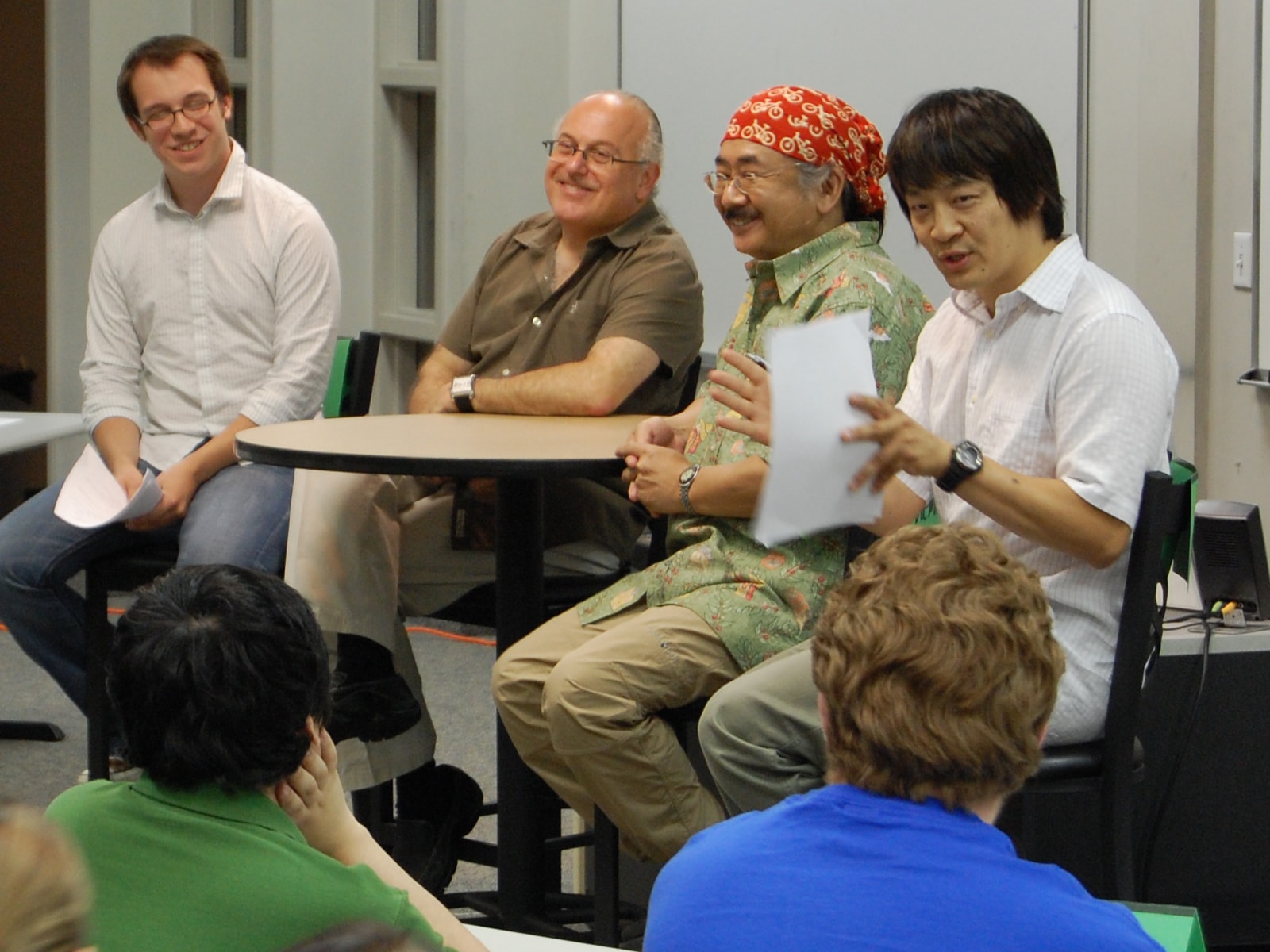 Nobuo Uematsu and Arnie Roth speak to students in a DigiPen classroom