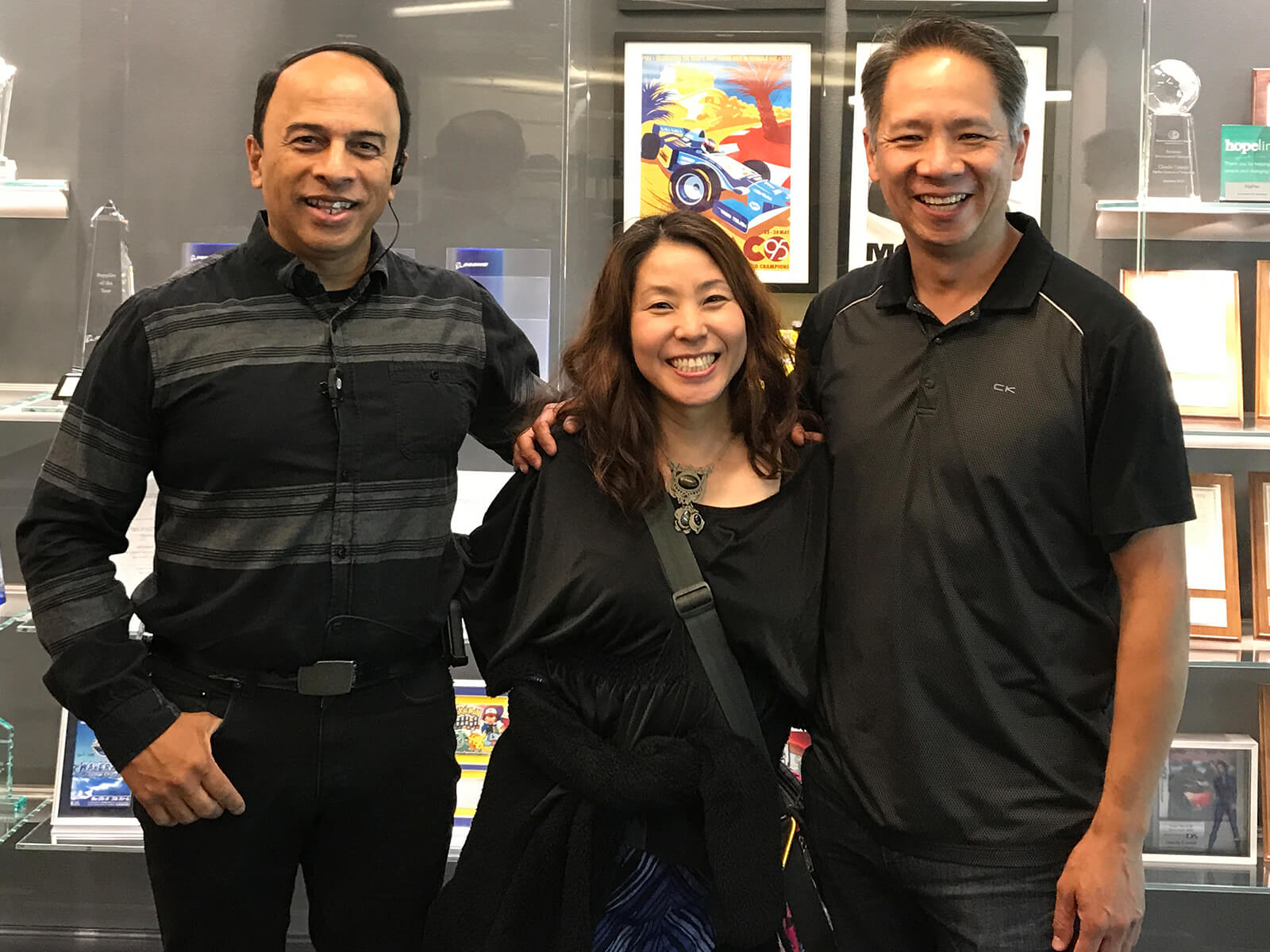 Satomi Asakawa stands next to her former DigiPen professors Ray Yan and Melvin Gonsalvez.
