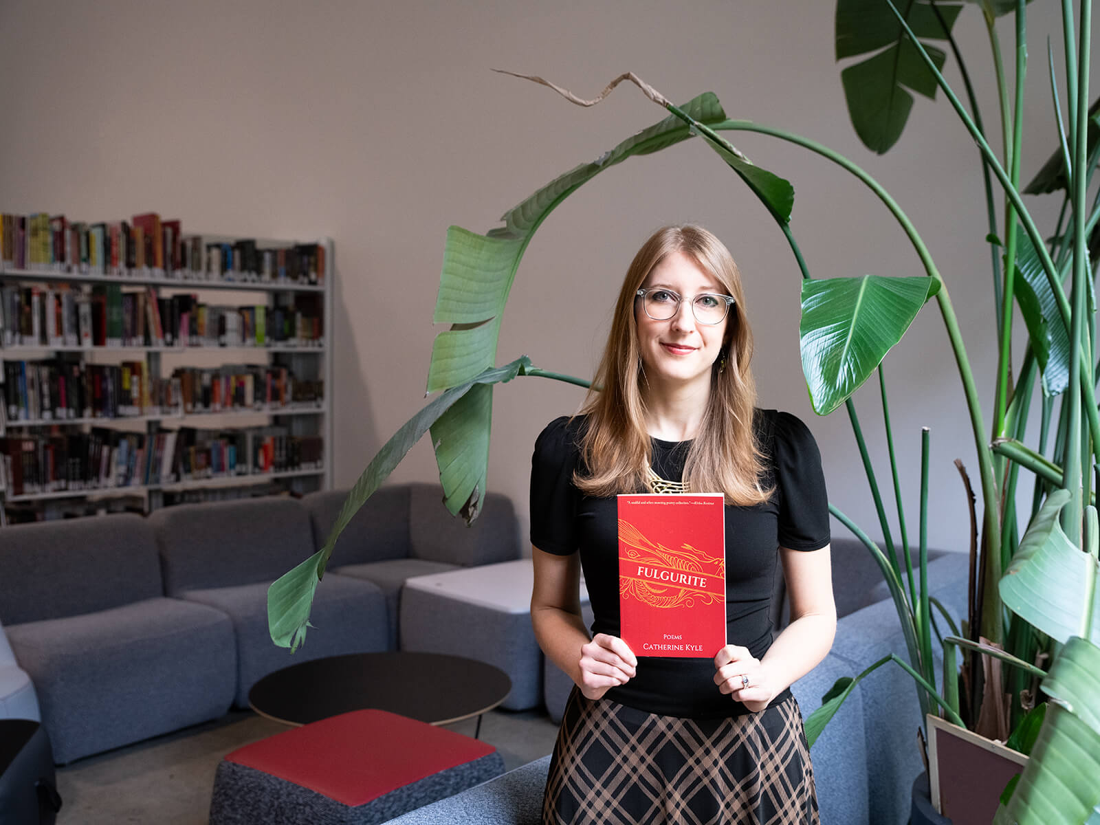 Catherine Broadwall holds up a copy of her book, Fulgurite.