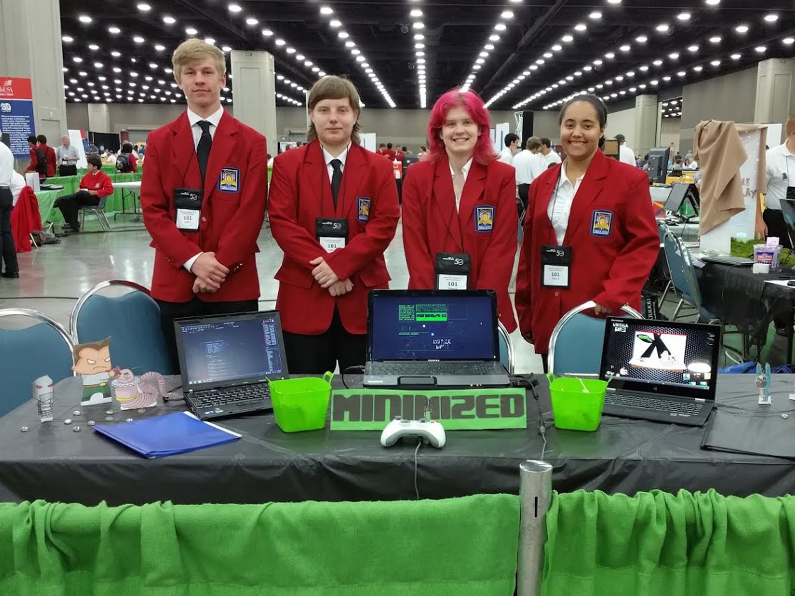 DigiPen WANIC Academy students posing in matching red jackets at their booth at the SkillsUSA competition