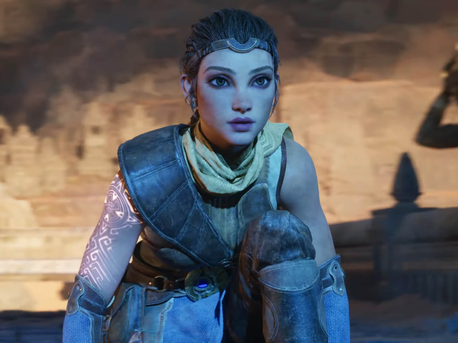 A screenshot, taken from the Unreal Engine 5 demo, of a woman with glowing runes on her arm, crouching in a cave.