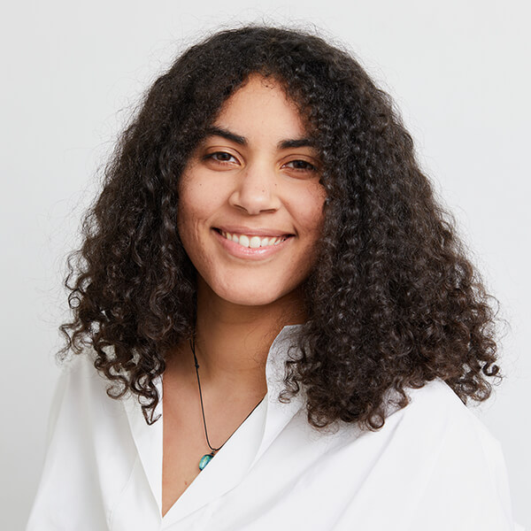 A headshot of DigiPen graduate Apol Vick smiling against a white background.