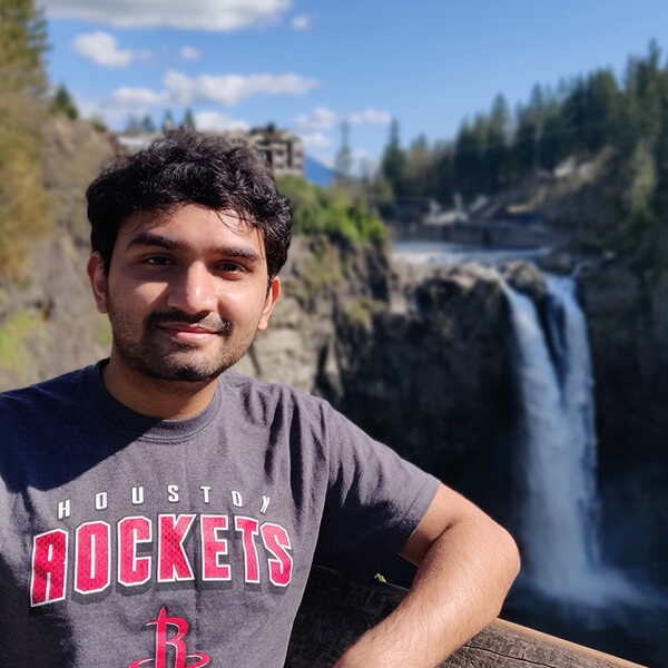 DigiPen MS in Computer Science graduate Dhrumil Shukla poses in front of Snoqualmie Falls