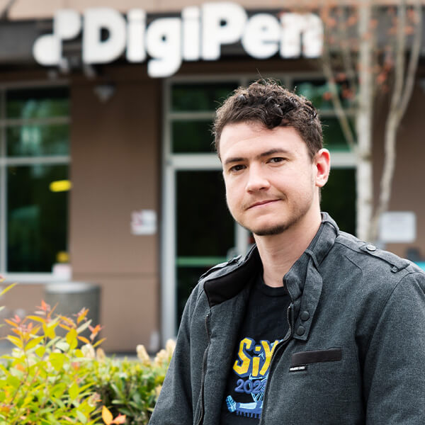 Outgoing DigiPen Student Union President Li Buam stands in front of the DigiPen Campus