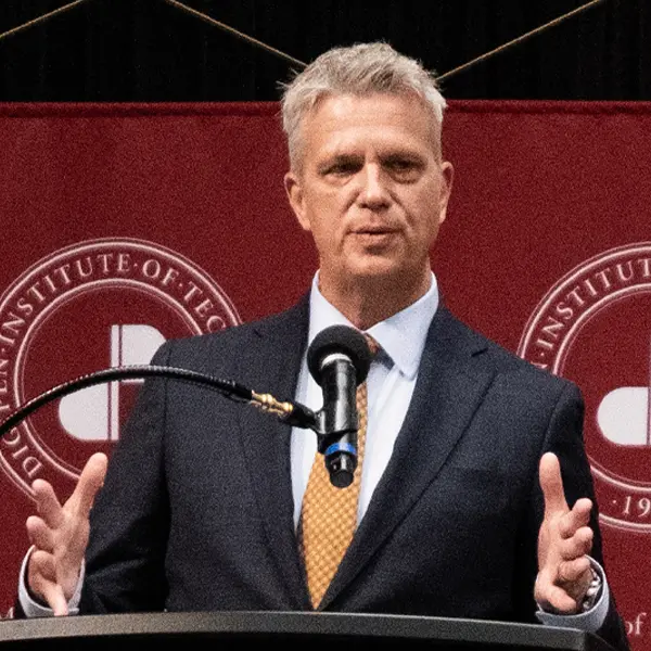 The commencement speaker speaks into a microphone.