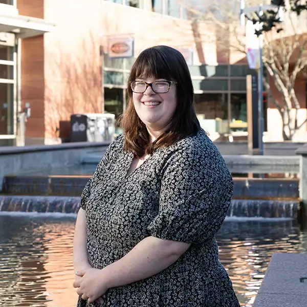 Pamela Wolf poses in front of the Microsoft logo and sign at the Redmond campus.