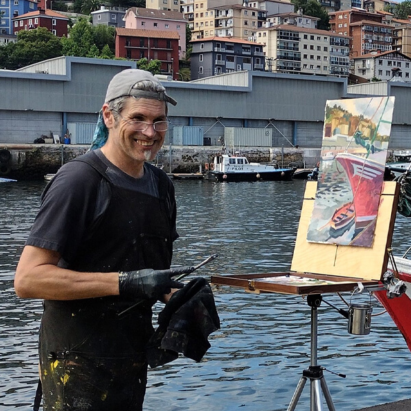 Steffon Moody stands and smiles as he paints the surrounding harbor and boat onto his canvas