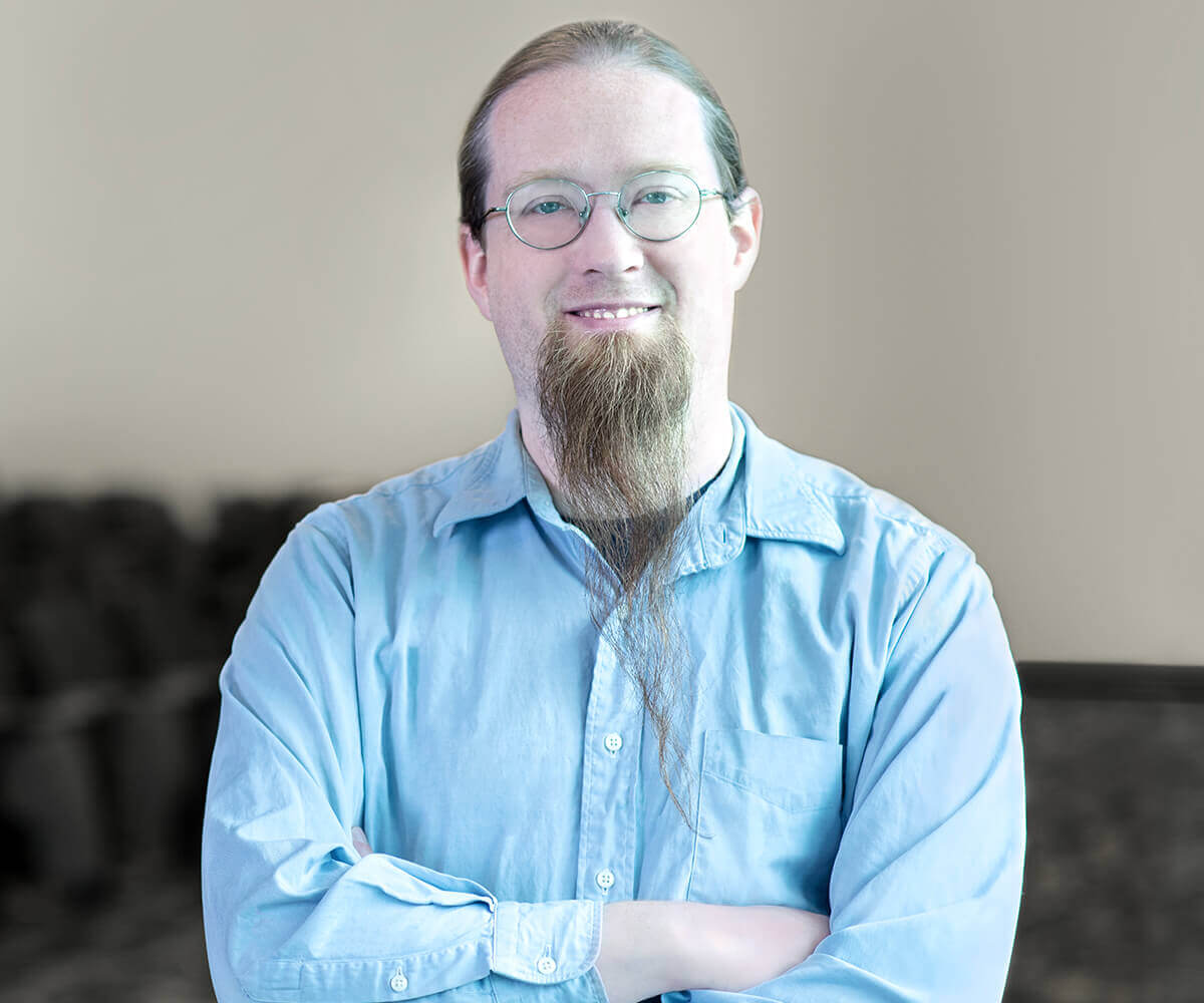 Jeremy Holocomb smiling and wearing a blue shirt