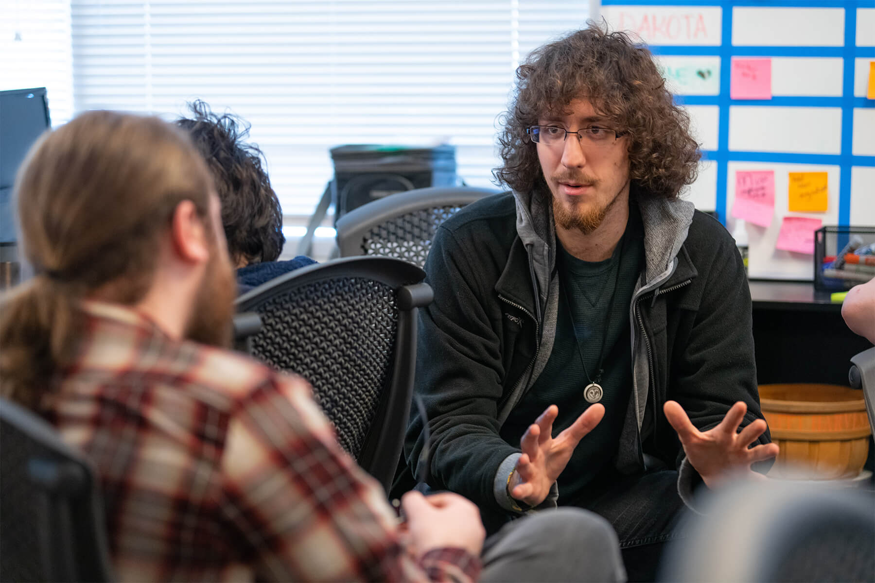 Two DigiPen students discuss their game team projects in DigiPen’s Tesla lab.