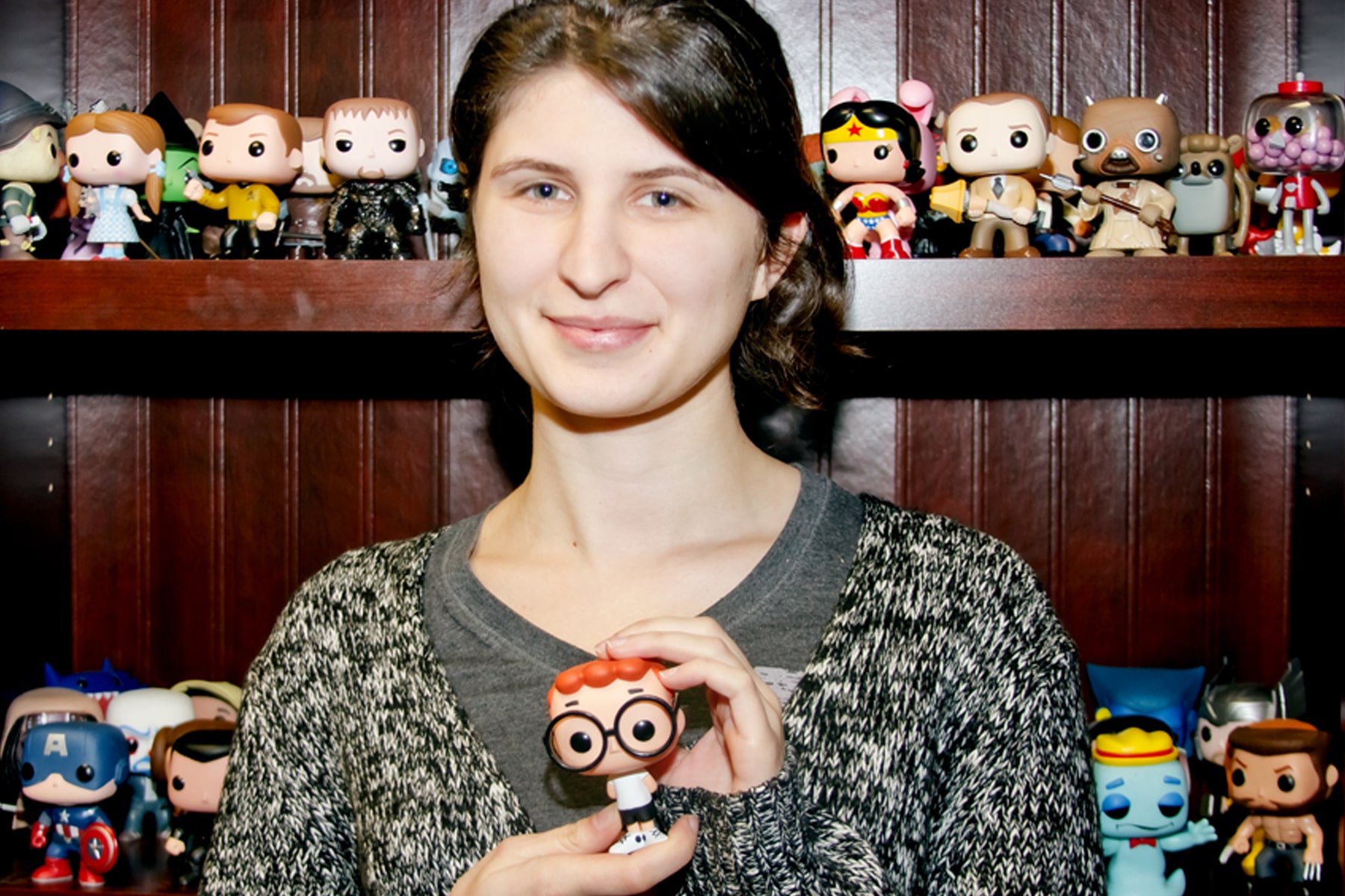DigiPen BFA graduate Anna Chiknavaryan holding the finished Mr. Peabody and Sherman figurine she sculpted on the computer