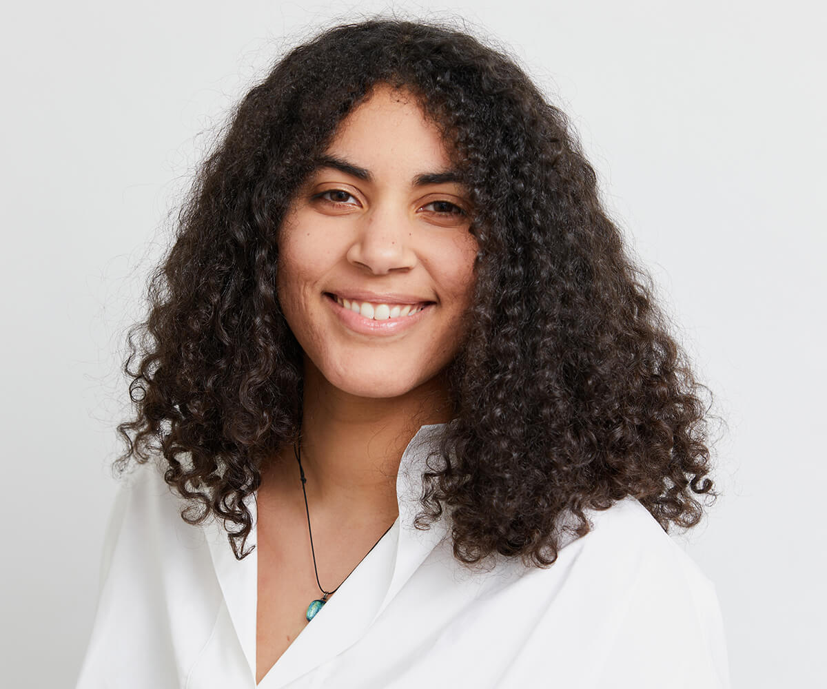 A headshot of DigiPen graduate Apol Vick smiling against a white background.