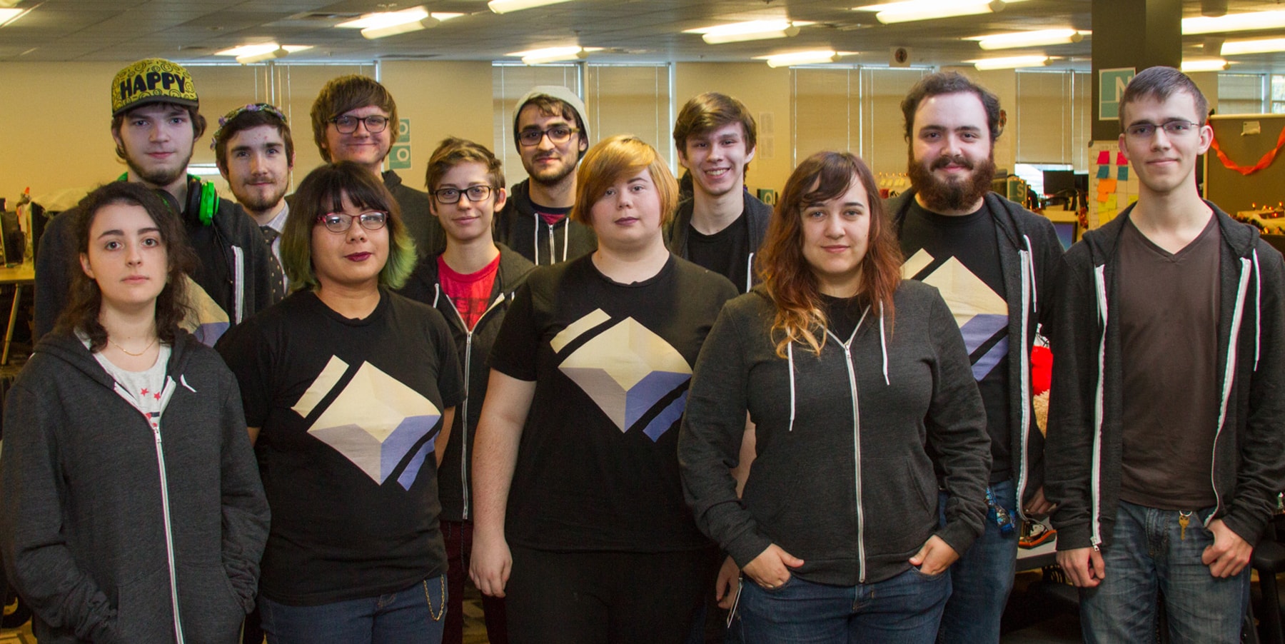 Twelve members of Team Isogon posing in a DigiPen lab