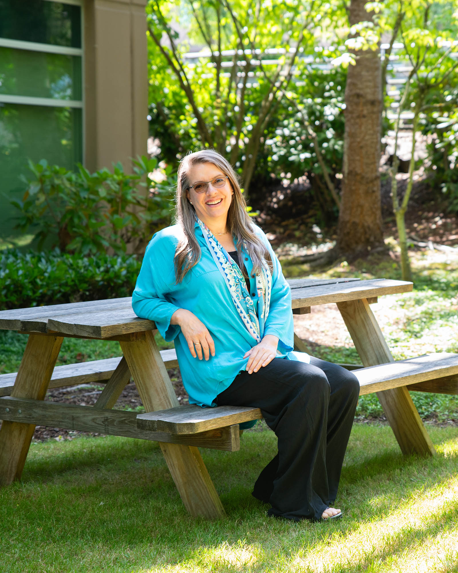 Brigitte Samson relaxes and sits outside the DigiPen campus.