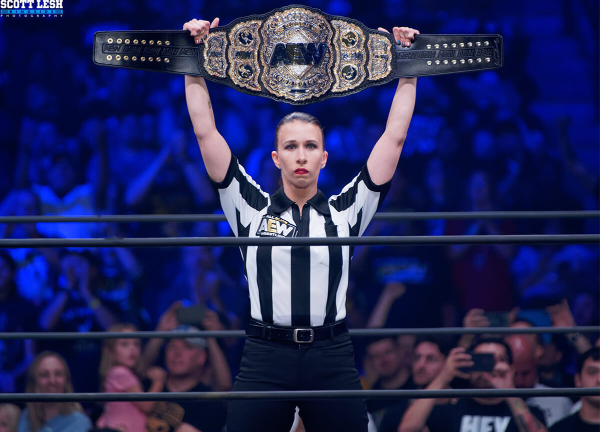 Referee Aubrey Edwards presents the AEW Championship Belt at All Out.