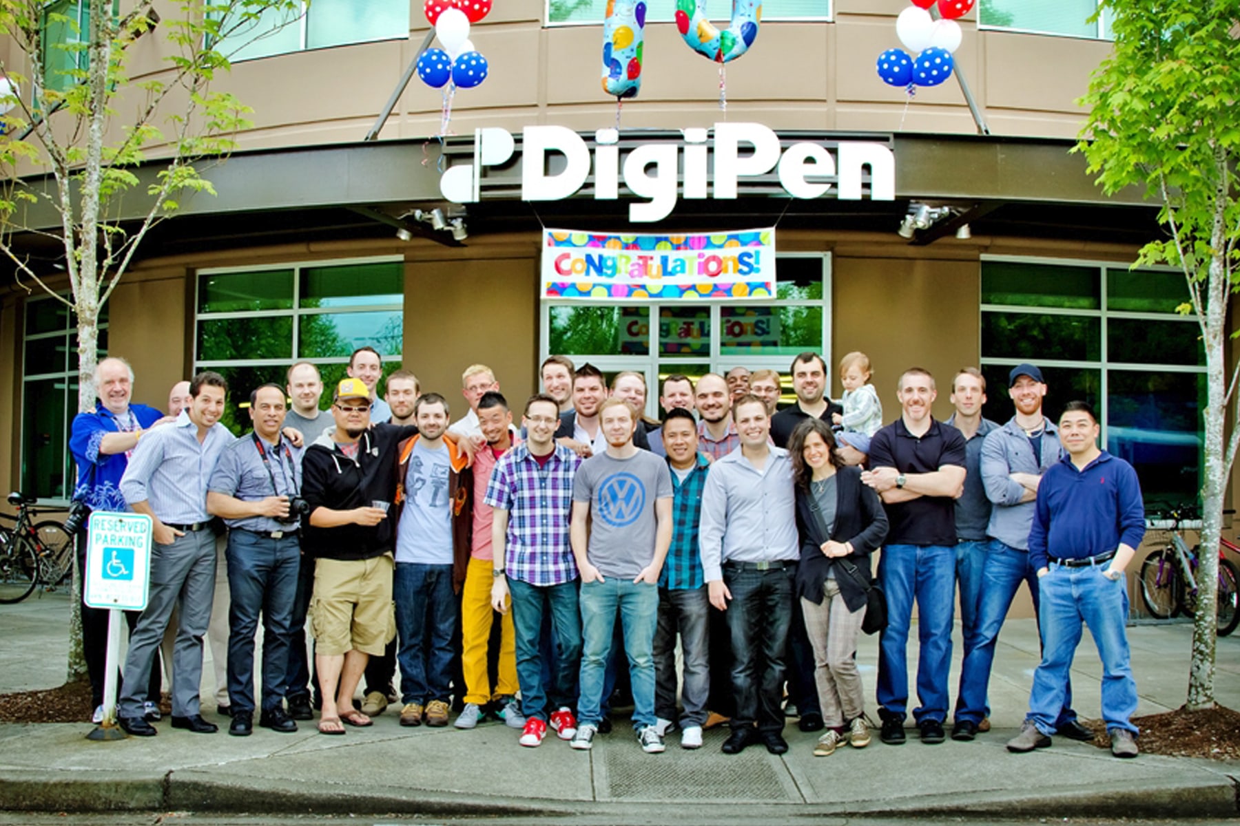 Group photo of 2003 AA in 3D Computer Animation program graduates in front of the DigiPen building