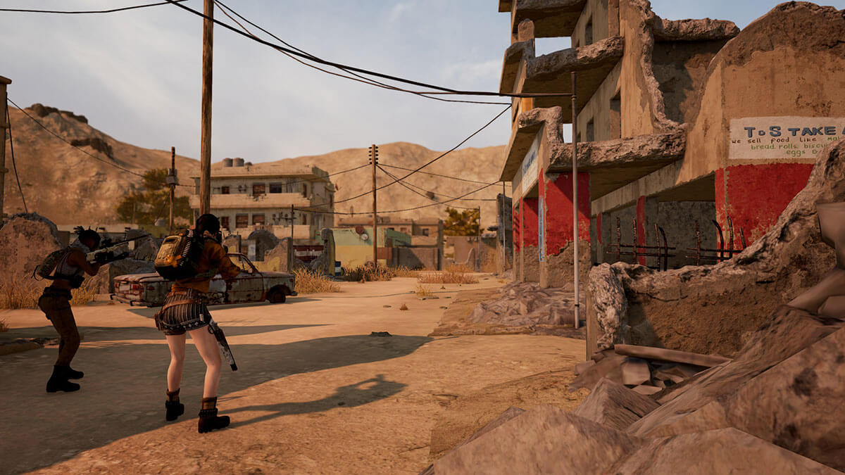 Two female characters ready their rifles in an abandoned western town