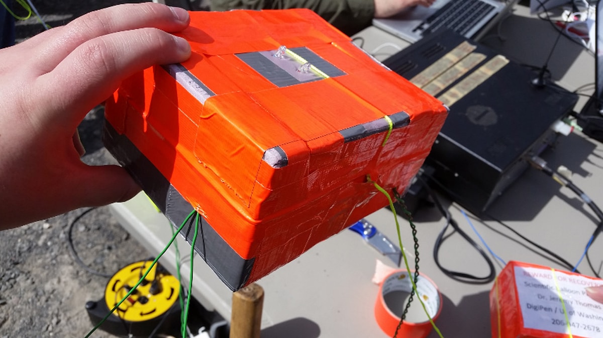 The exterior of a payload wrapped in bright orange material