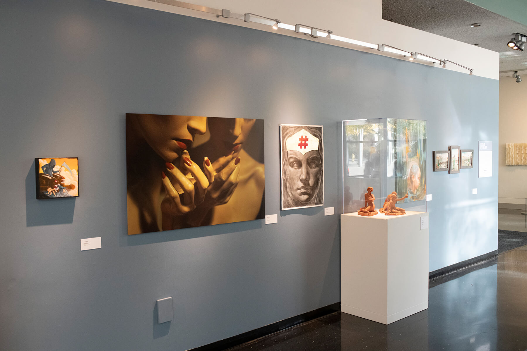 Various faculty art pieces — including photography, drawing, sculpture, and more — on display at the Bellevue Art Museum.