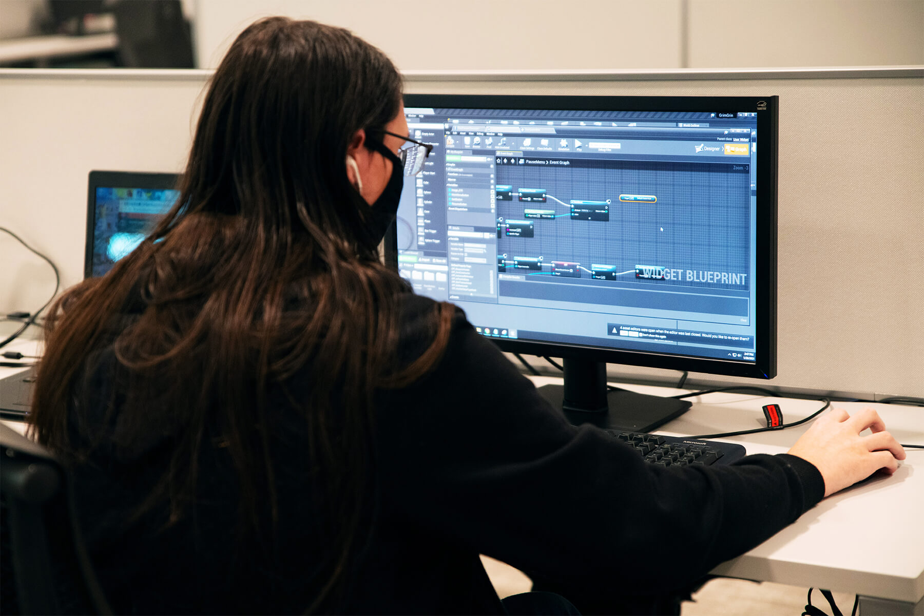 A student doing visual scripting on their computer in DigiPen’s production lab.