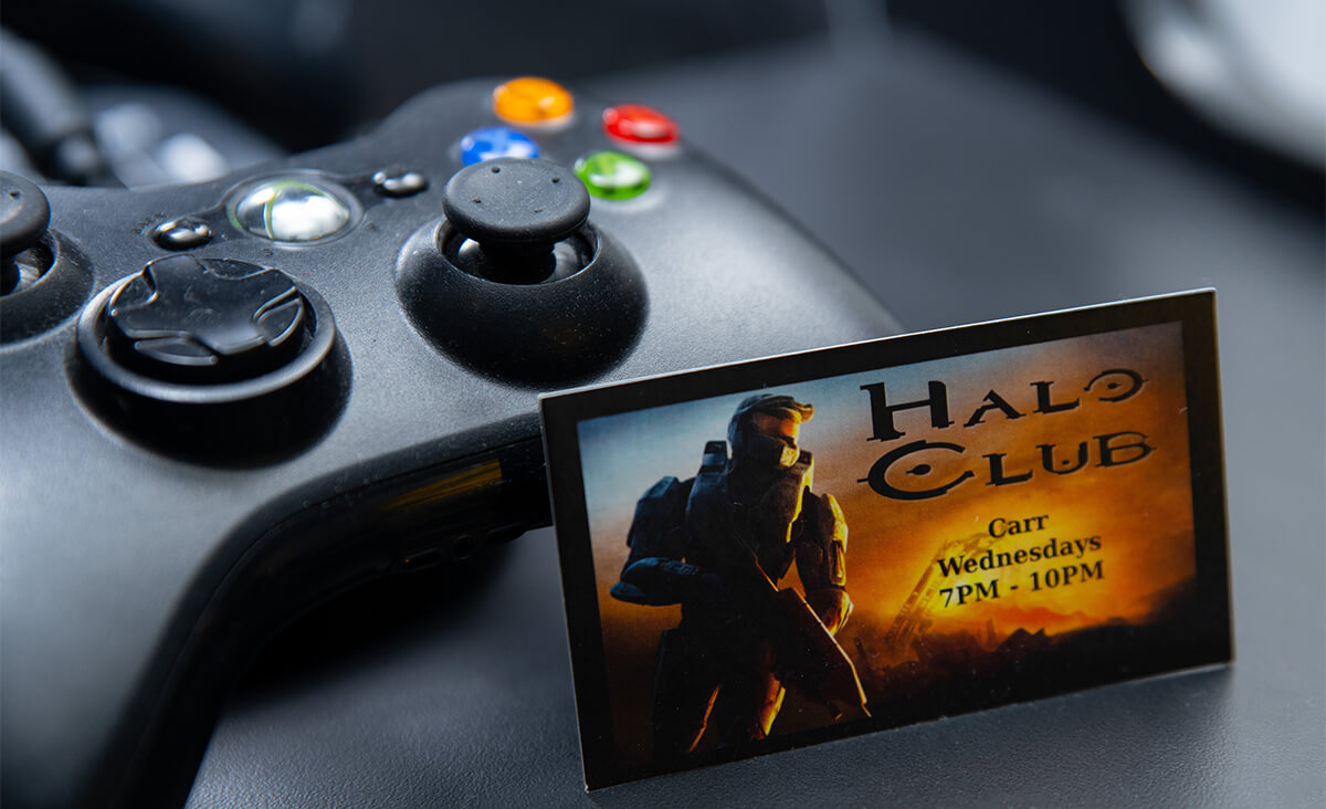 A DigiPen Halo Club business card rests against an Xbox controller.