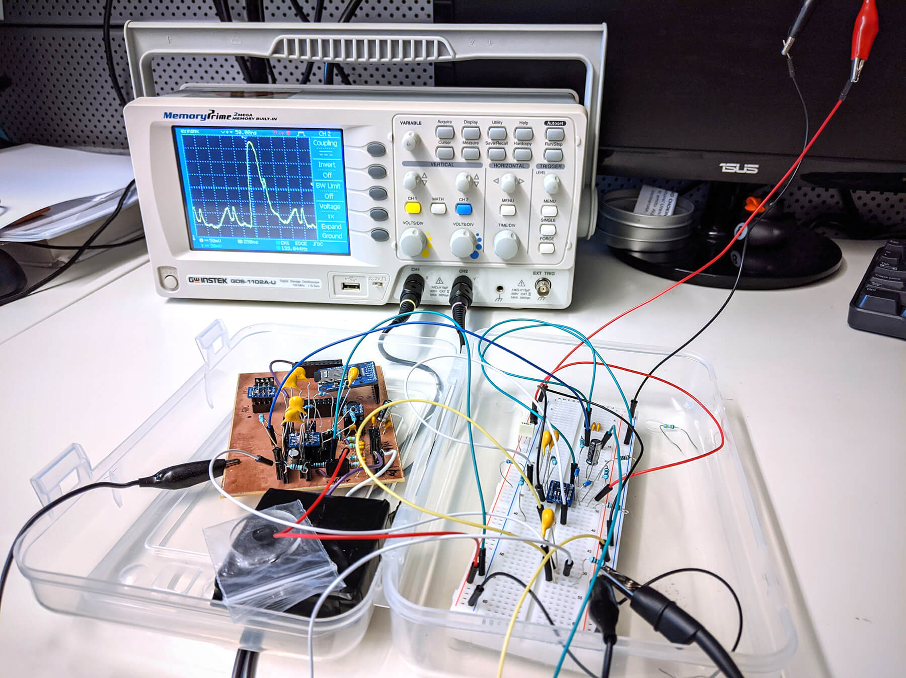 A circuit board surrounded by wires connecting it to an electrical device.