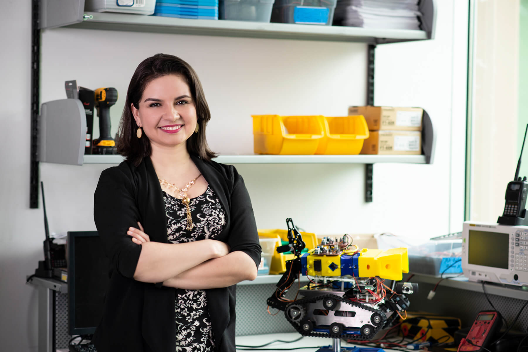 DigiPen professor Lorena Villarreal poses with her smelling robot in a DigiPen lab