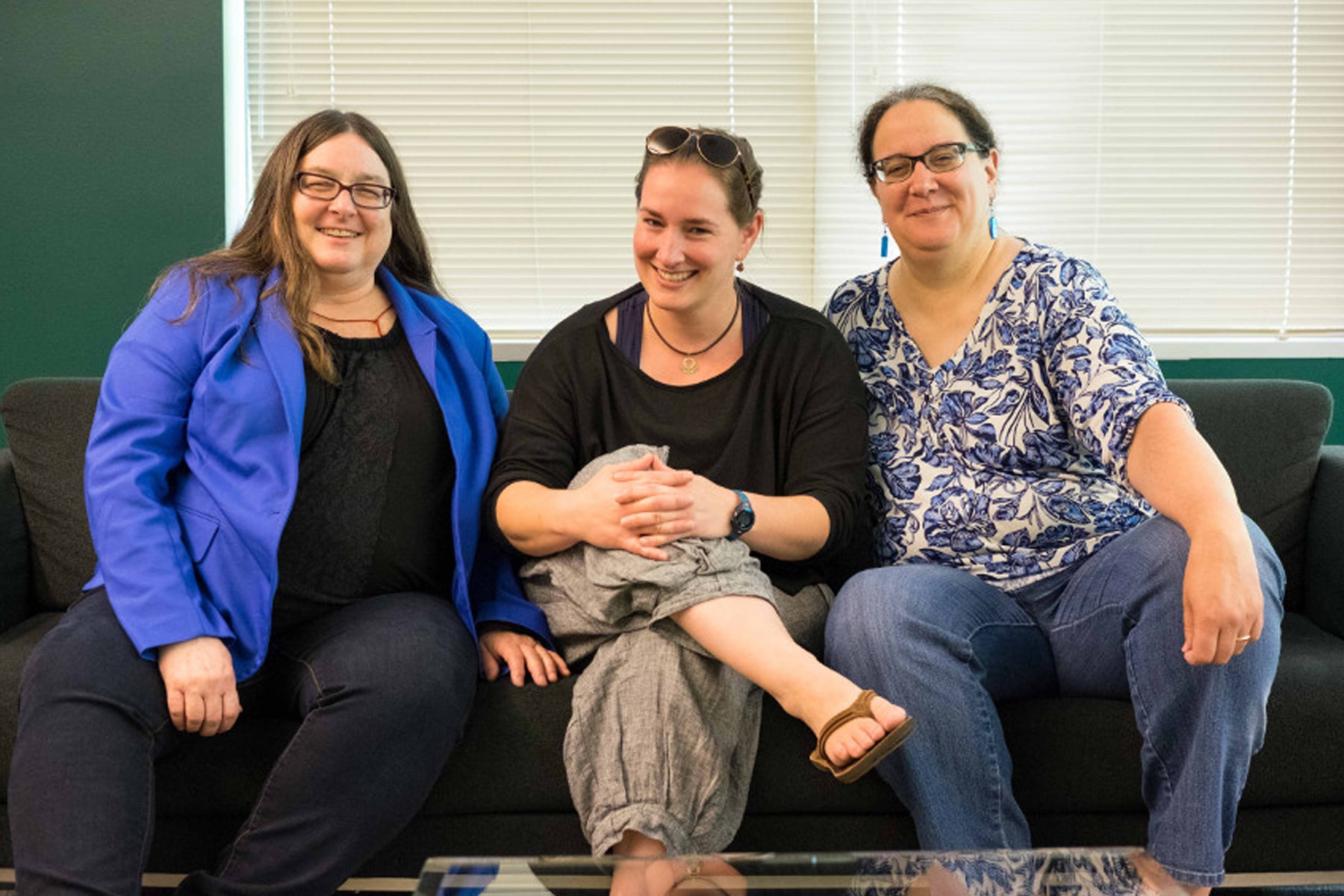 DigiPen instructors Rachel Rutherford and Ellen Beeman sitting with Tiltan School faculty member Yael Maritz