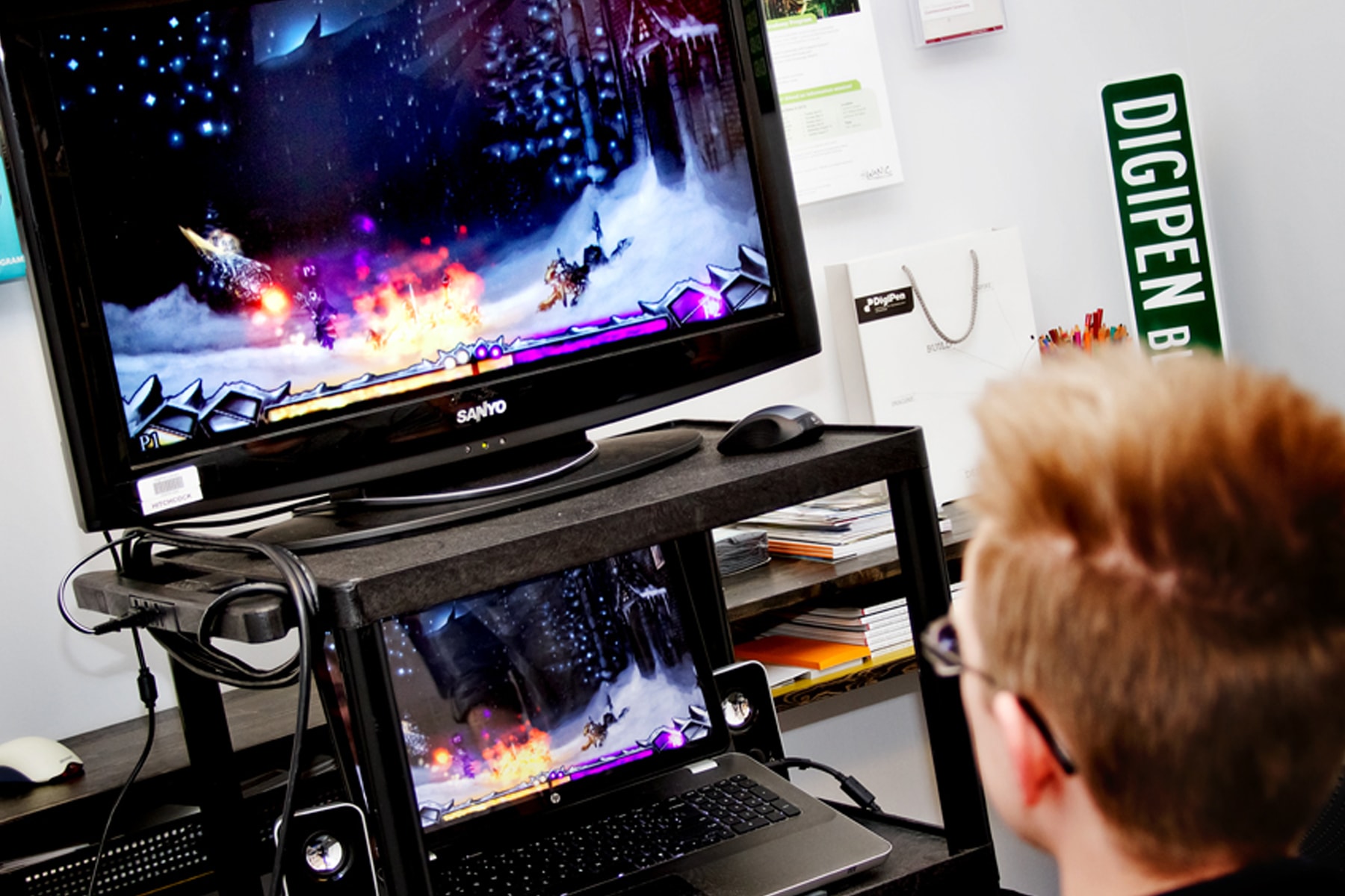 A DigiPen student playing Frozen Masquerade in a DigiPen conference room