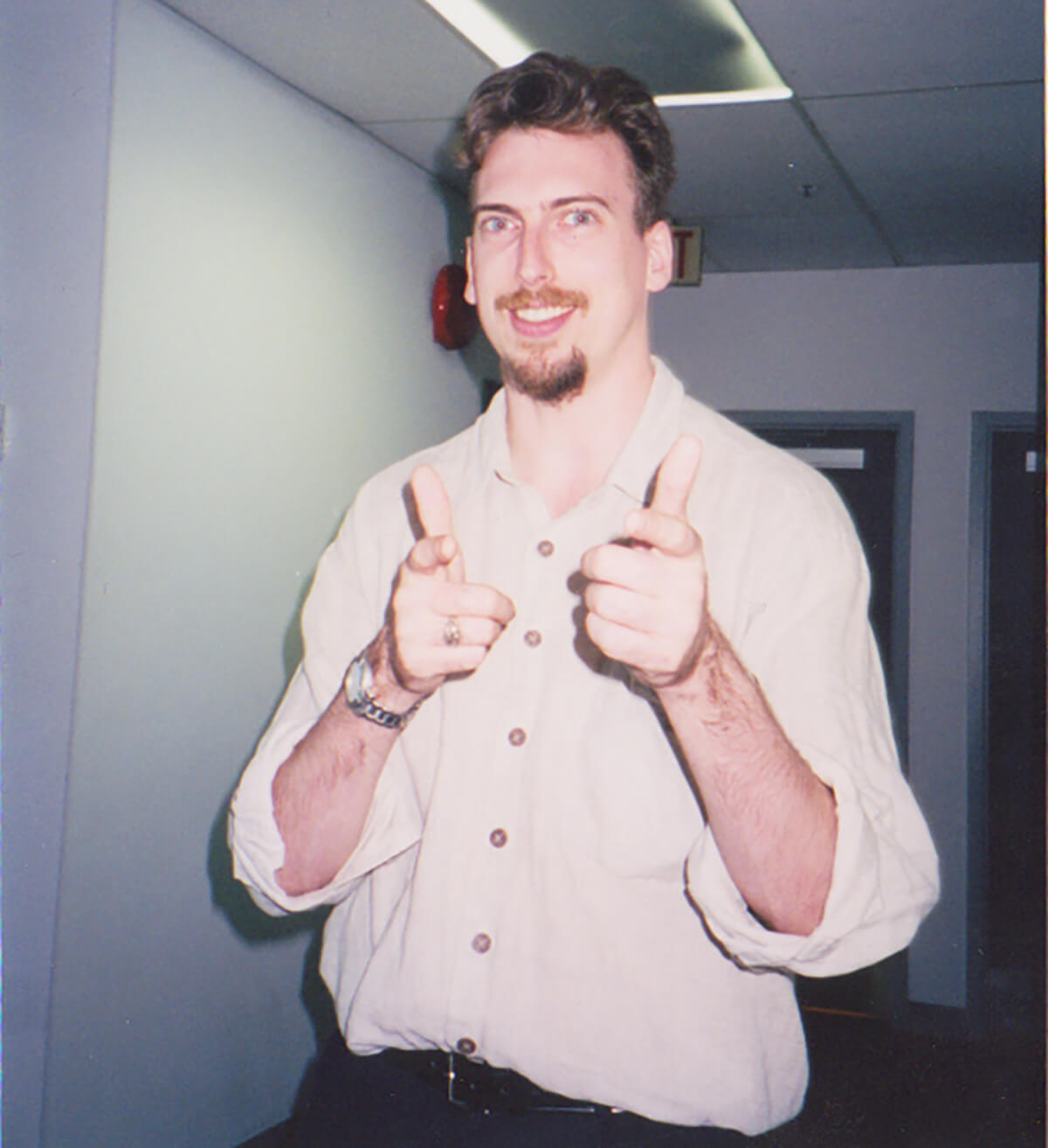 A young Duncan Shields smiles and makes finger guns for the camera in this picture from his days as a DigiPen student.