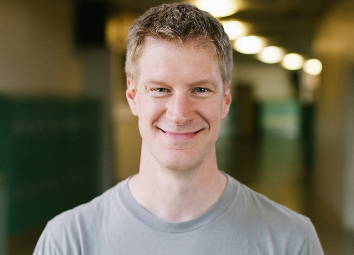 DigiPen Dean of Faculty Erik Mohrmann smiling in a campus hallway