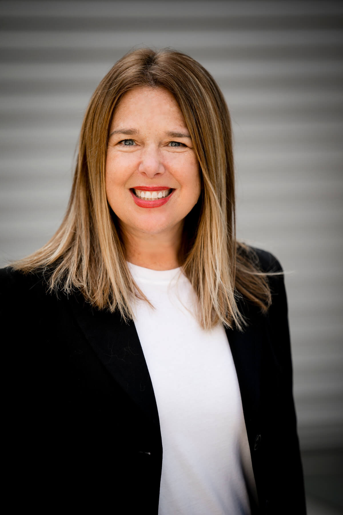 Susanna Pollack wearing a black suit smiling