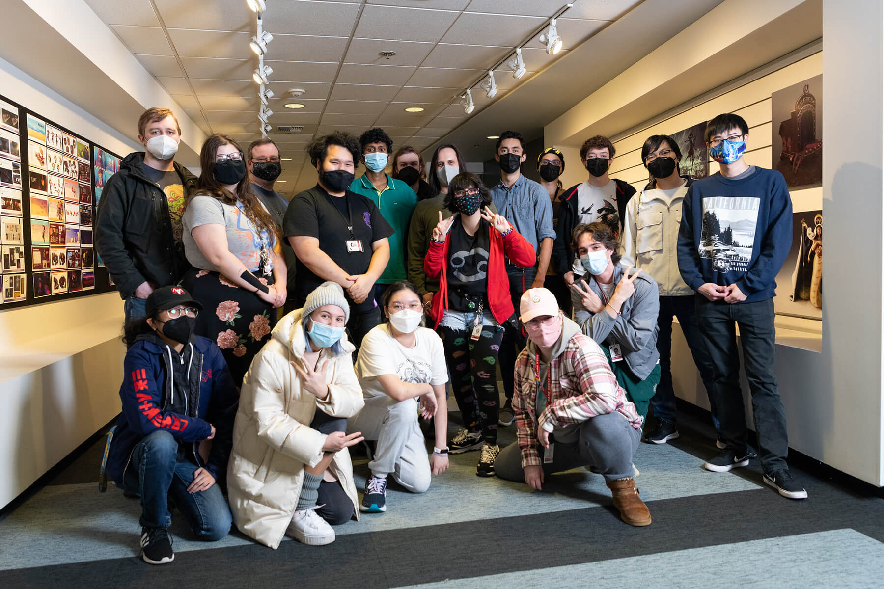 Members of Team Slippers pose for a group shot in a campus hallway.