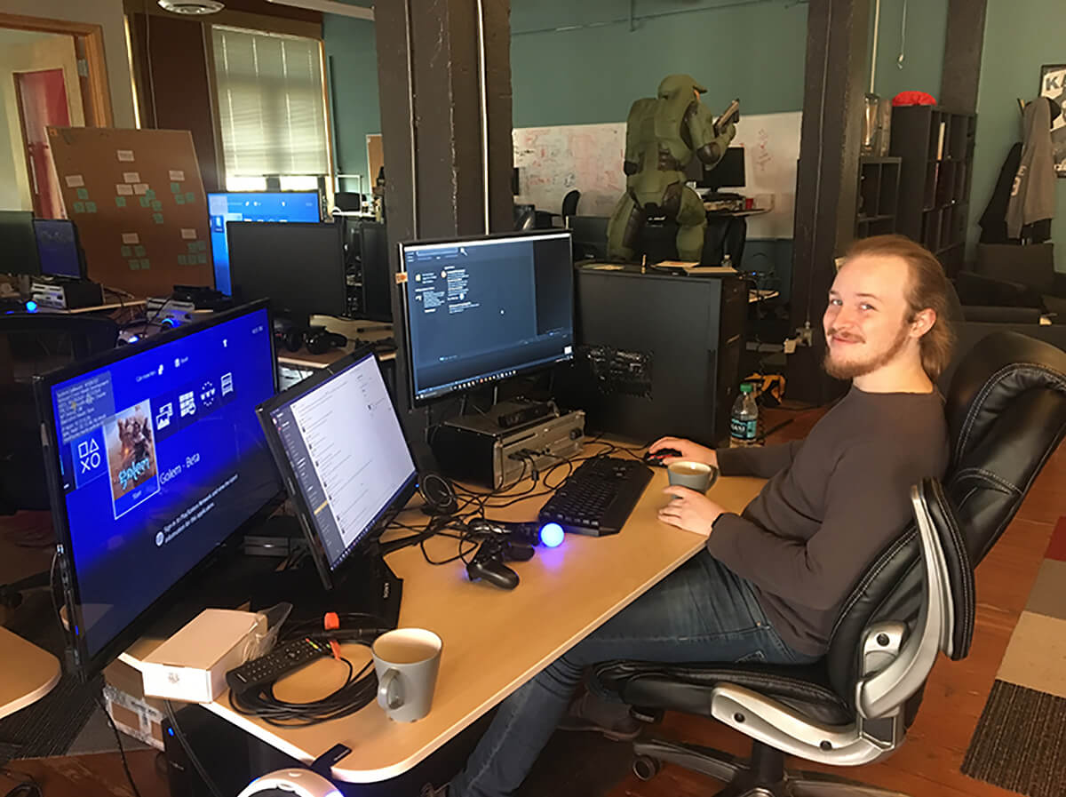 DigiPen alumnus Ian Shores sits at his desk at the Highwire Games office