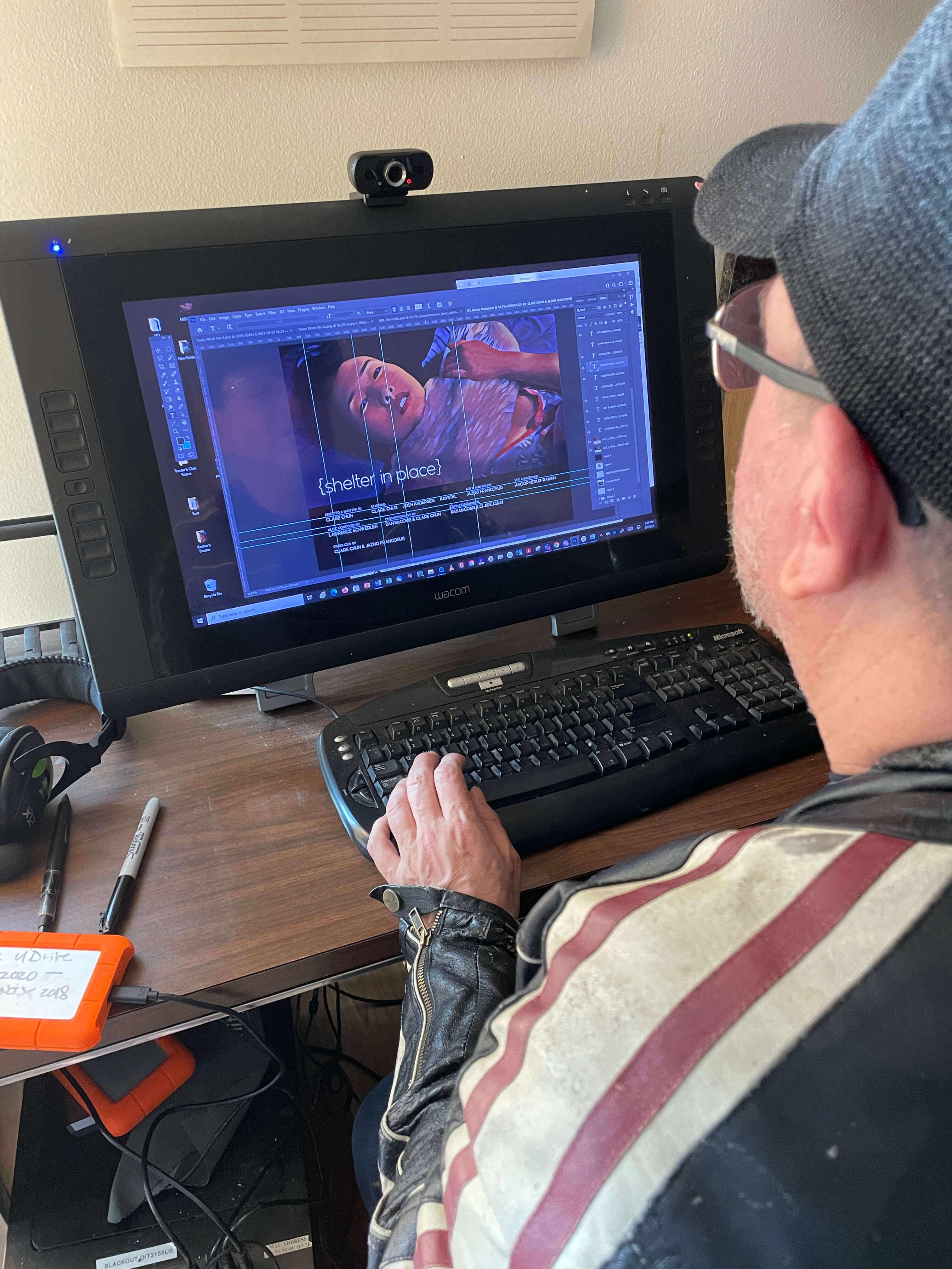 Over-the-shoulder view of Jazno Francoeur working at a computer.