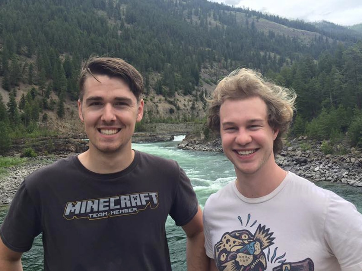 Jake Shirley and Craig Steyn posing in front of a river with mountains in the background