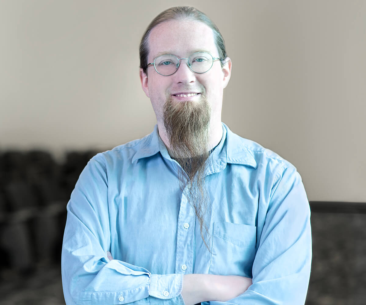 Game Design Program Director Jeremy Holcomb smiles for the camera in a DigiPen auditorium.