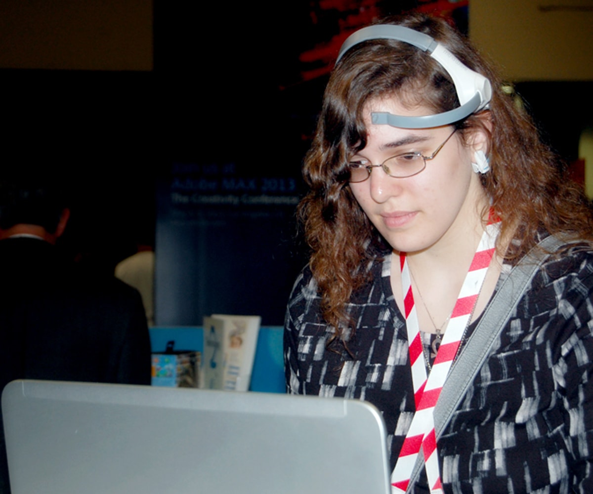 A GDC attendee wearing an EEG headset to play Throw Trucks With Your Mind