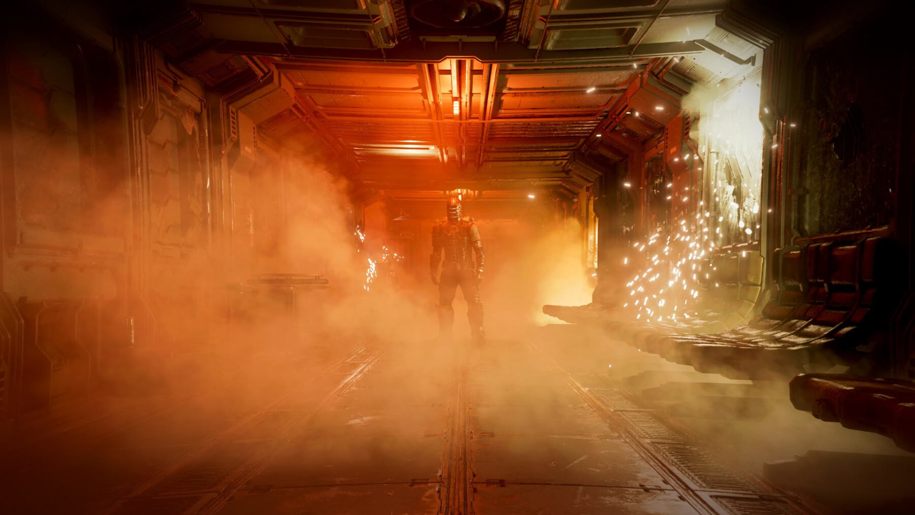Dead Space protagonist stands in a spaceship corridor flooded with fog and enveloped in orange, reddish light.